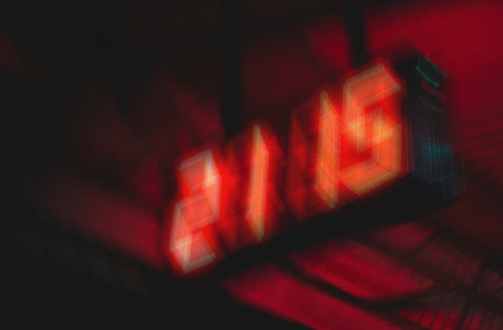 Image of blurred clock and red lights